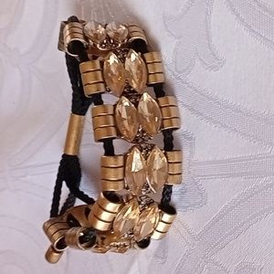 J Crew gold tone bracelet with large gold crystal stones strung on a black cord